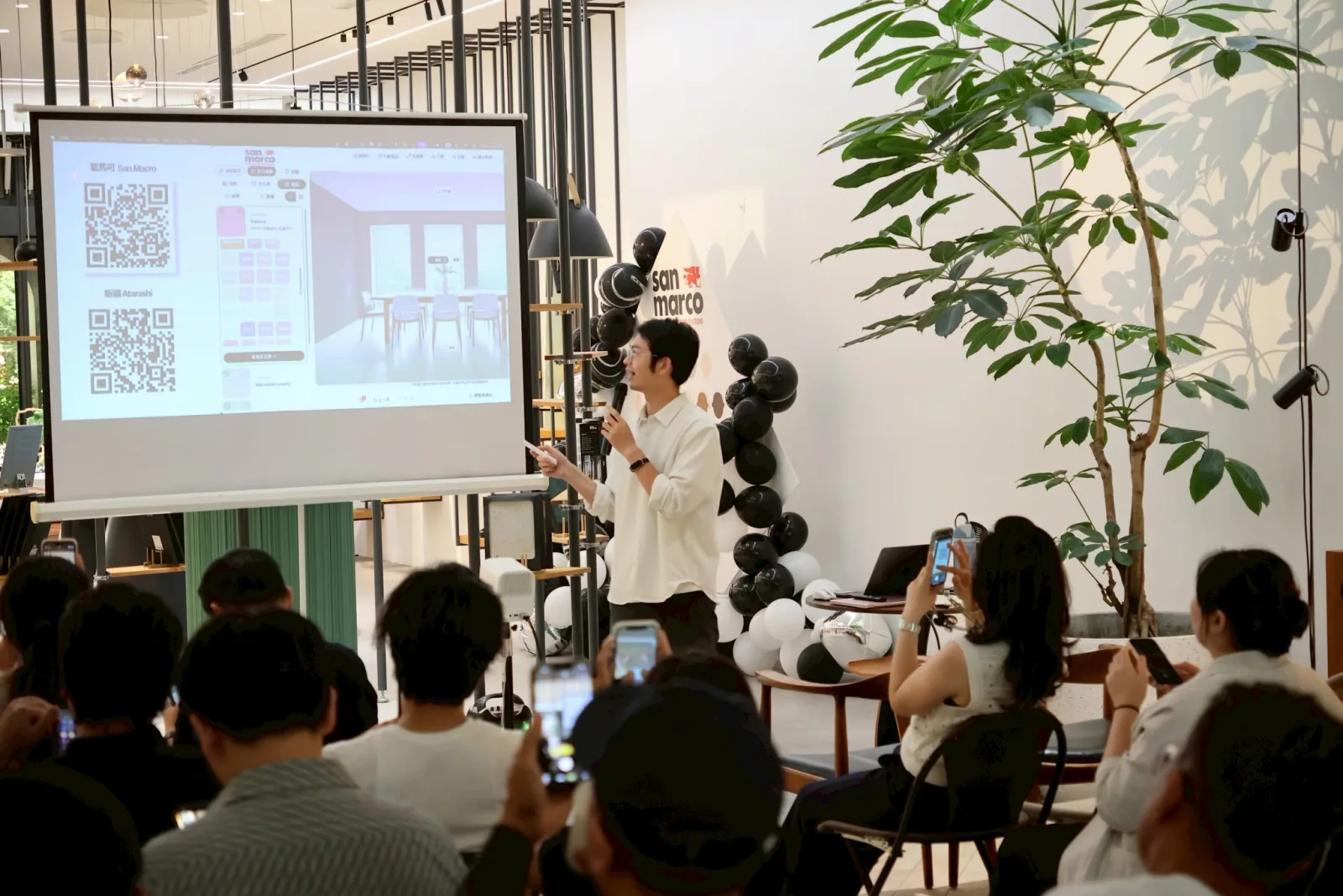 Designers scanning the projected QR code to open the AI visualizer on their phones